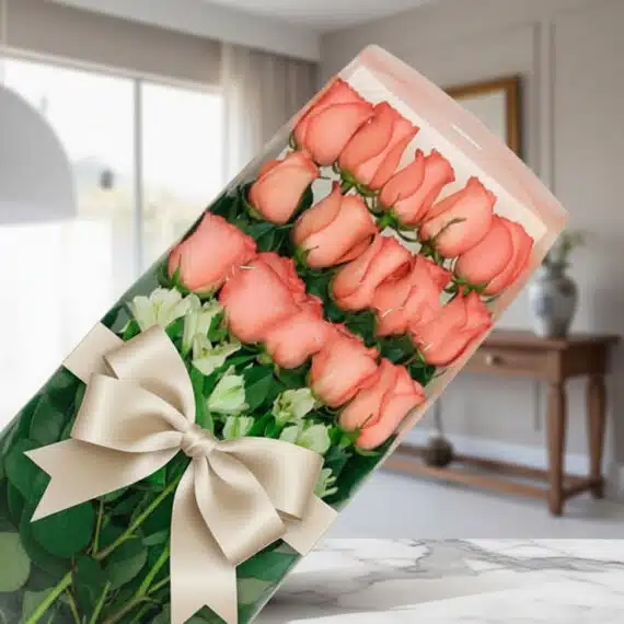 Caja de 18 Rosas Rosadas: Regalo Perfecto para Toda Ocasion Caja de 18 rosas rosadas frescas y vibrantes con un elegante moño beige, presentadas en un fondo sofisticado y bien iluminado